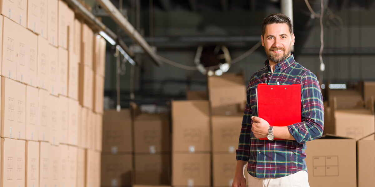 Man with clipboard in warehouse